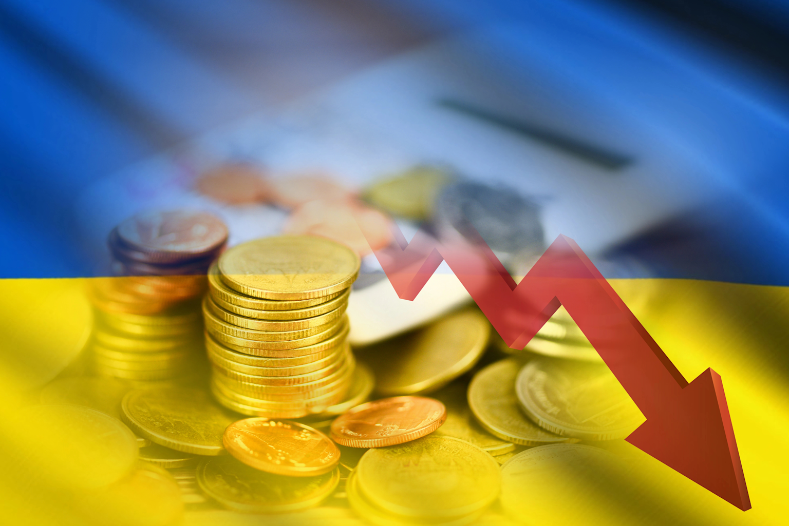 Stacked coins overlaid with the Ukrainian flag and a red downward arrow symbolizing economic decline in Ukraine