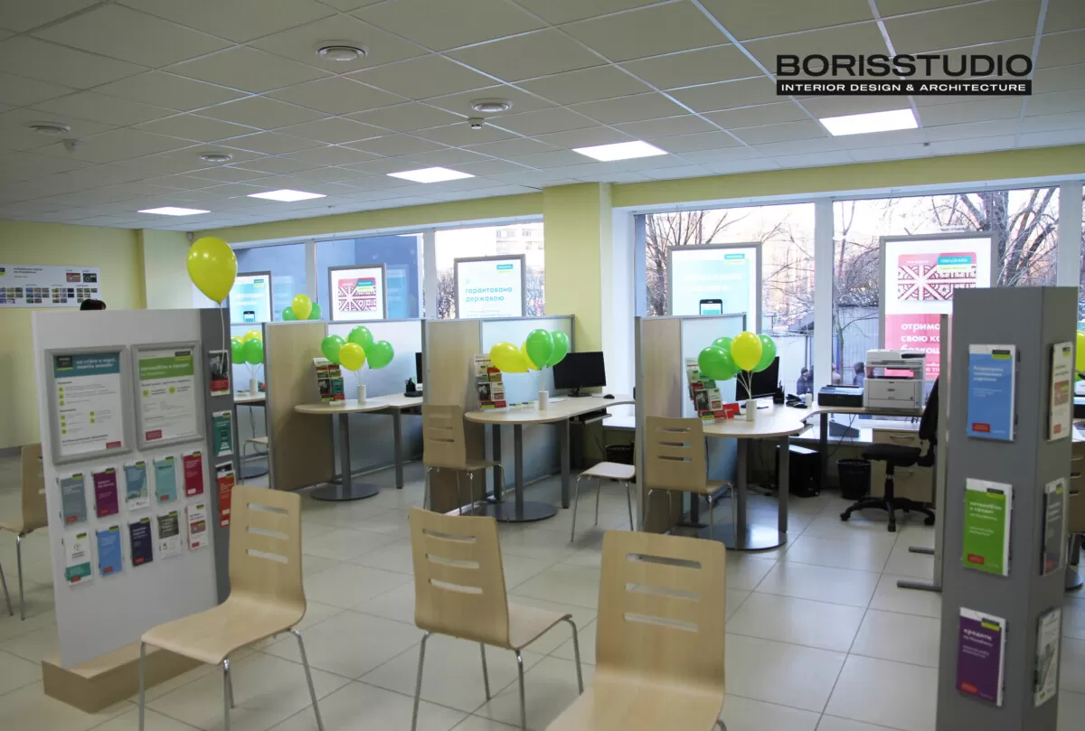 Interior of a Ukrainian bank branch with consultation desks, balloons, and waiting area chairs