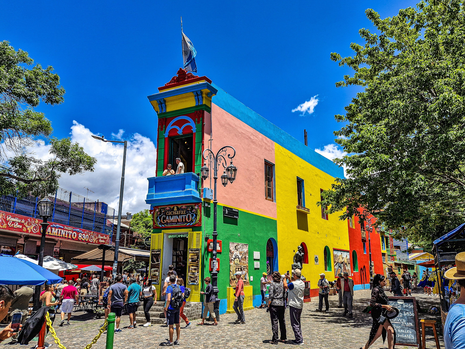 Colorful buildings and vibrant street life along Caminito street in Buenos Aires' La Boca neighborhood