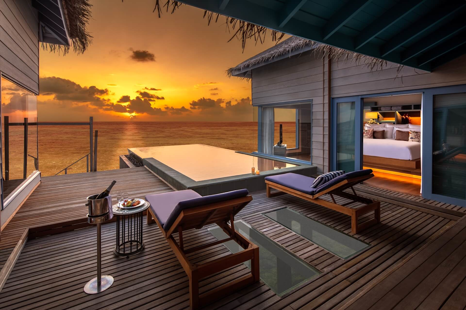Luxury overwater bungalow in the Maldives at sunset with a private pool and ocean views