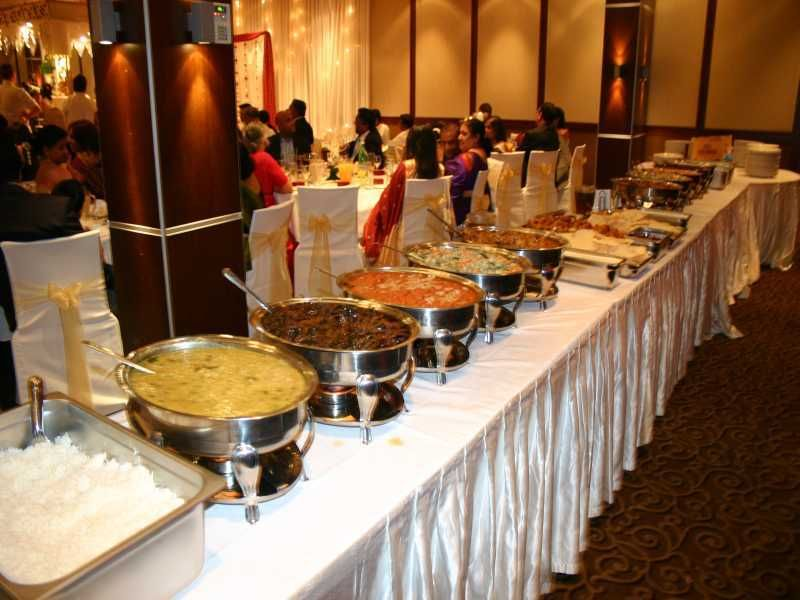 Professional wedding catering buffet with a variety of dishes served in warm and elegant setting