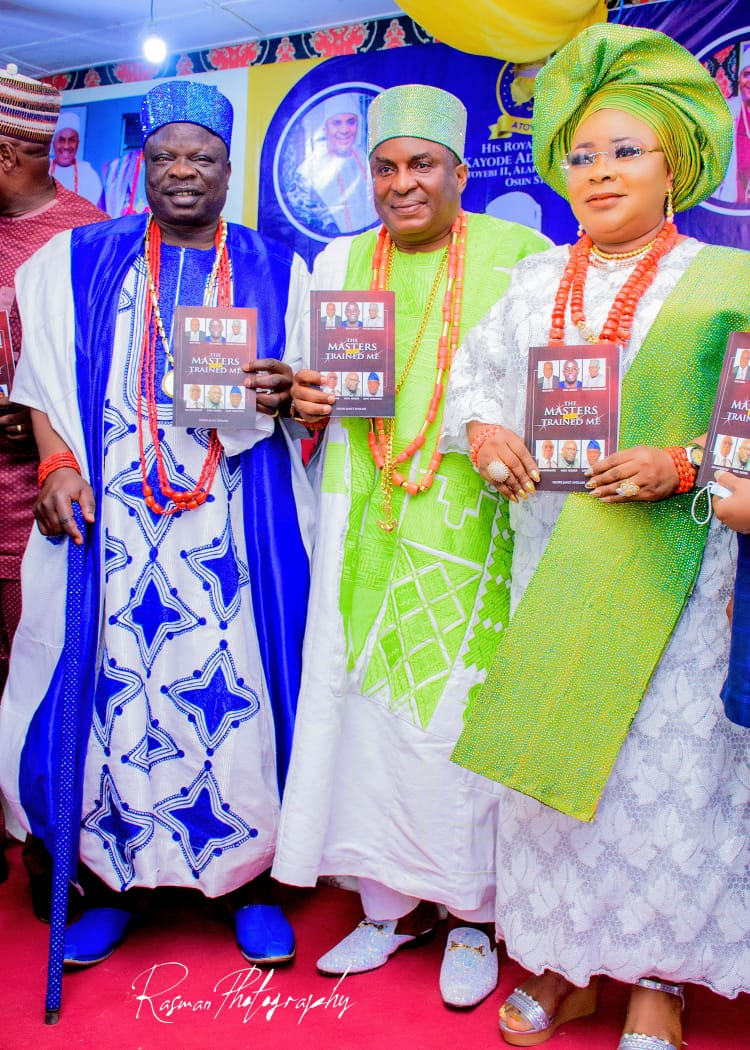 Olori Janet Afolabi and associates display the book 'The Masters Trained Me' at a cultural event