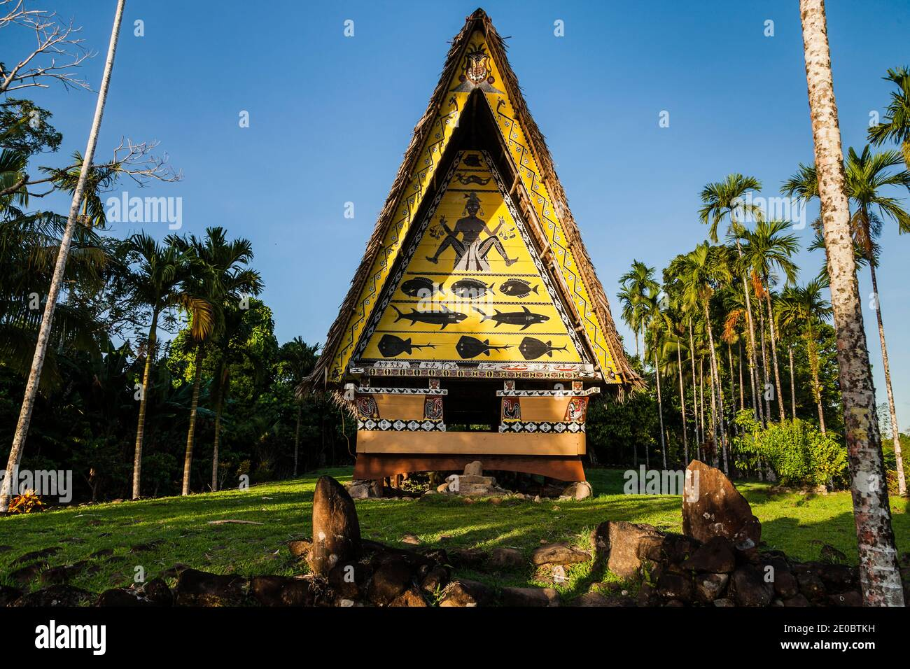 Traditional Palau bai meeting house with distinctive cultural artwork set amid lush tropical surroundings on Babeldaob island