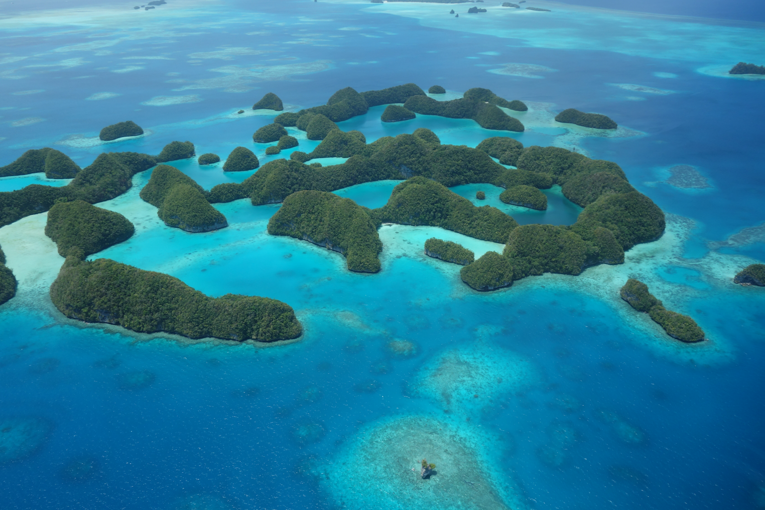 Aerial view of Palau's Rock Islands showcasing their unique limestone mushroom formations and vibrant turquoise waters