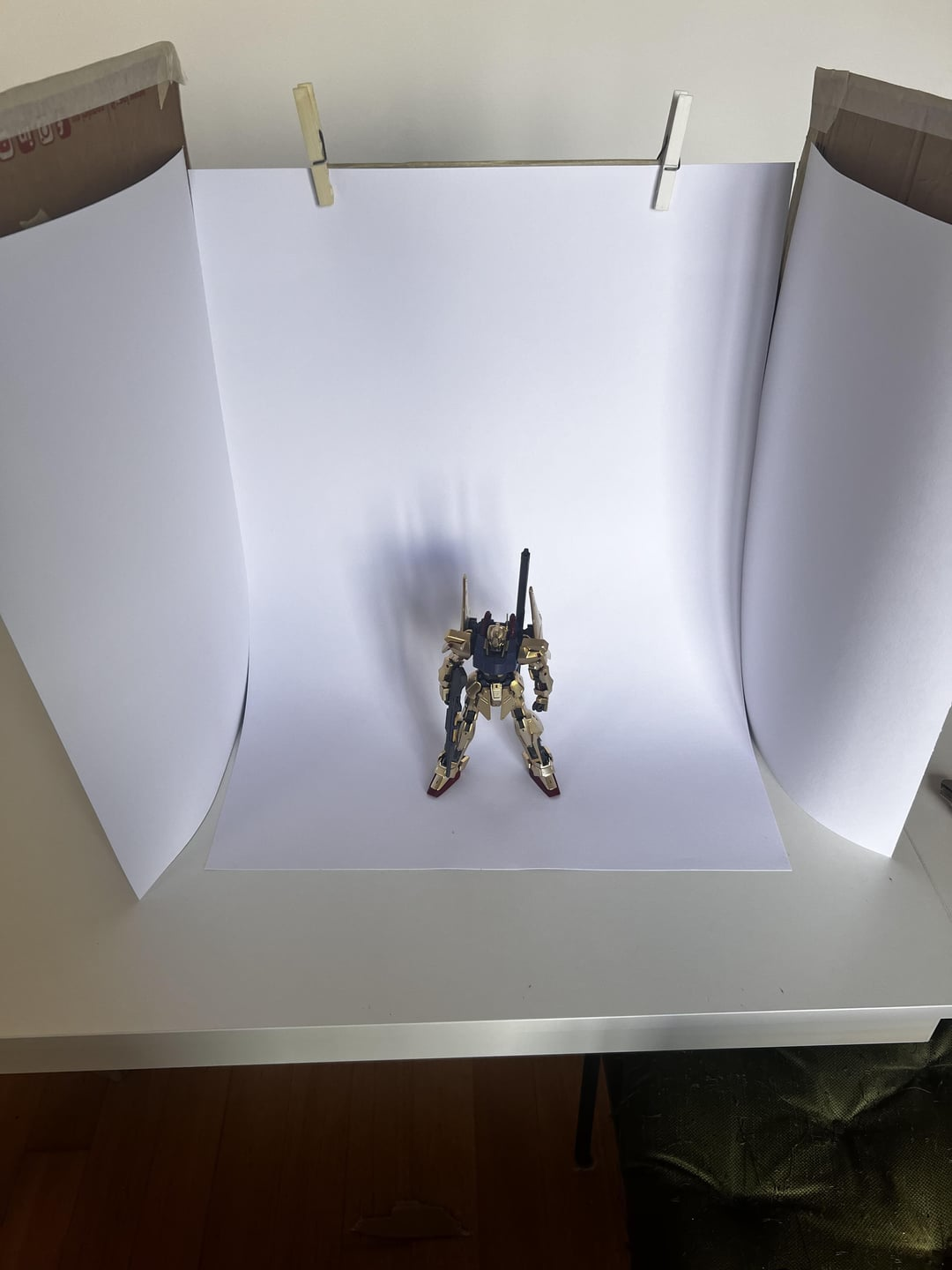 DIY lightbox made from cardboard and white paper for phone product photography.