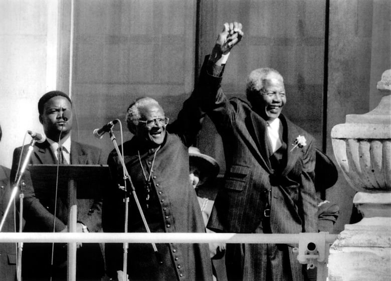 Archbishop Desmond Tutu and Nelson Mandela celebrate together, symbolizing the intersection of religious influence and political resistance in South Africa