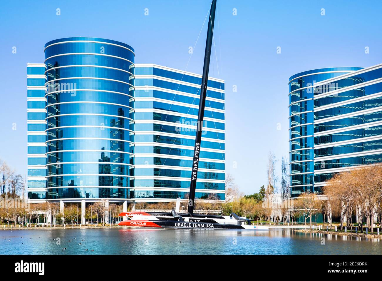 Oracle Corporation headquarters with modern reflective buildings and Oracle Team USA sailboat in Redwood City, California