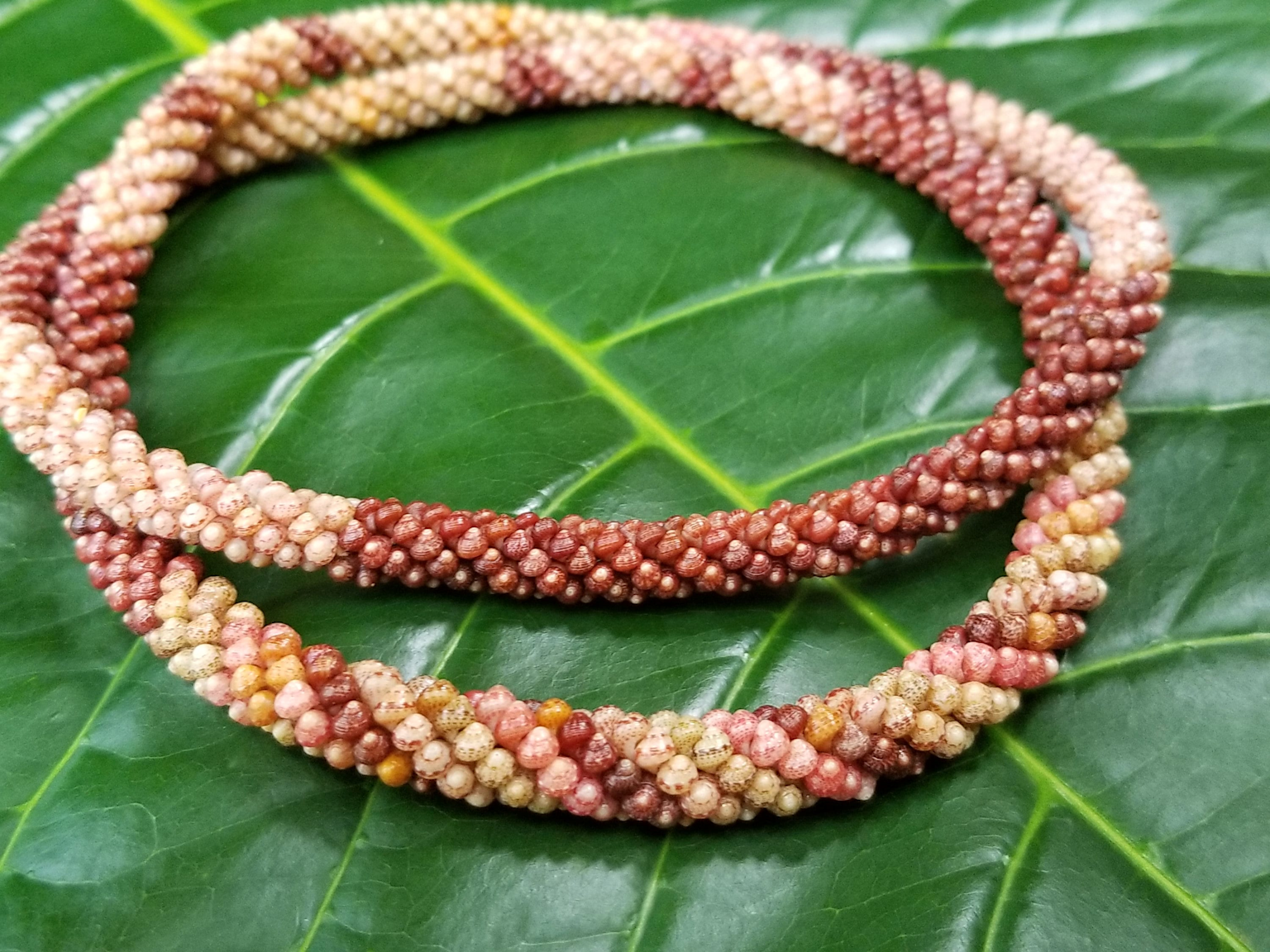 Authentic shell leis showcasing detailed craftsmanship often sought as Hawaiian souvenirs but sometimes involved in tourist scams