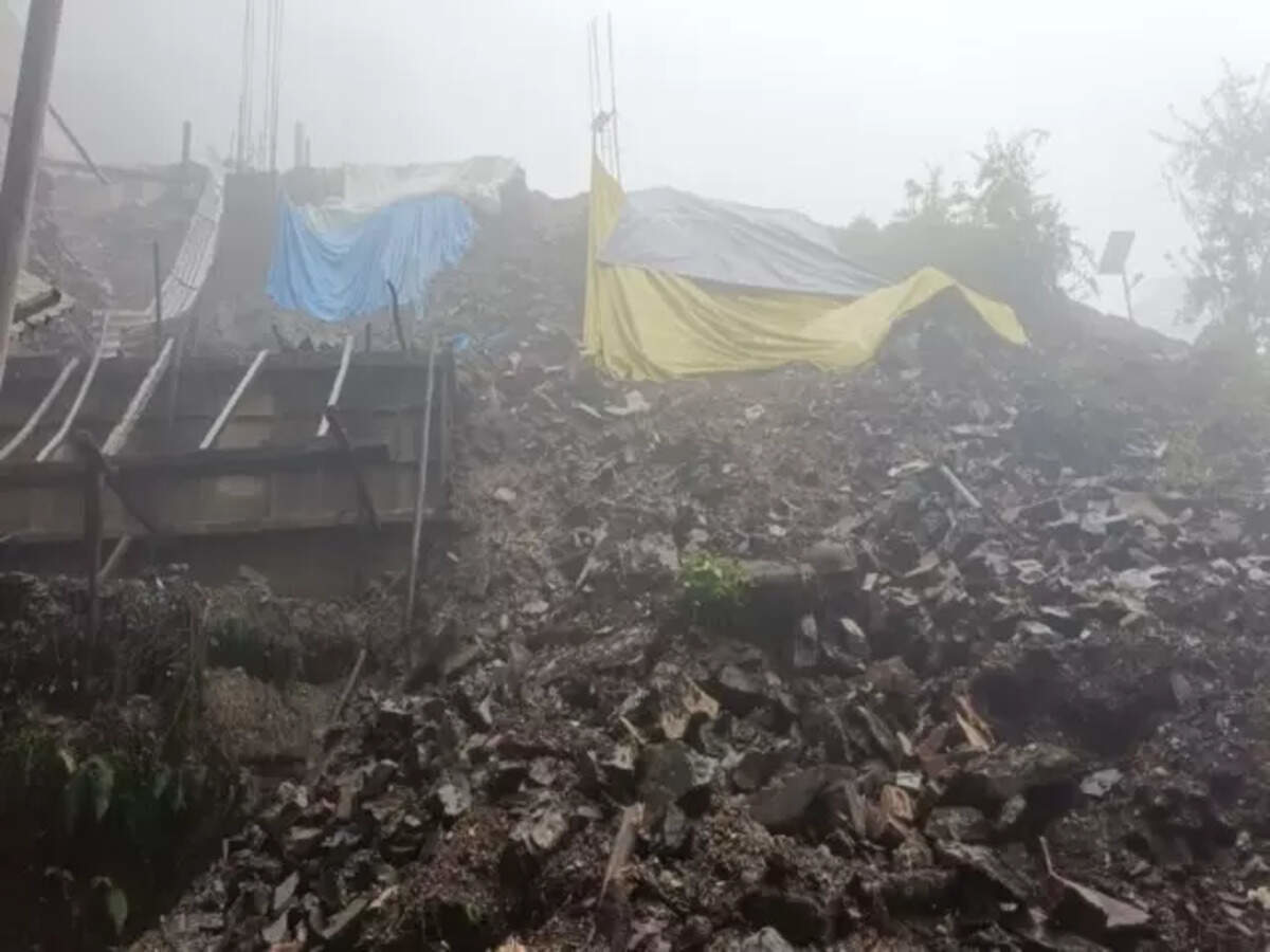 Landslide caused by heavy rainfall disrupts roads and construction in a foggy hilly area of Himachal Pradesh