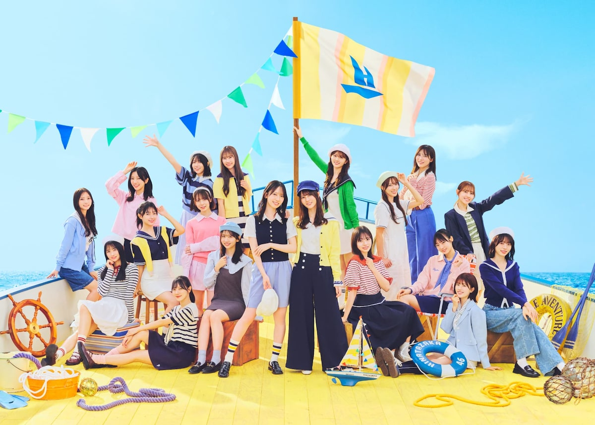 Members of Hinatazaka46 pose on a ship-inspired set for the "お願いバッハ" music video.