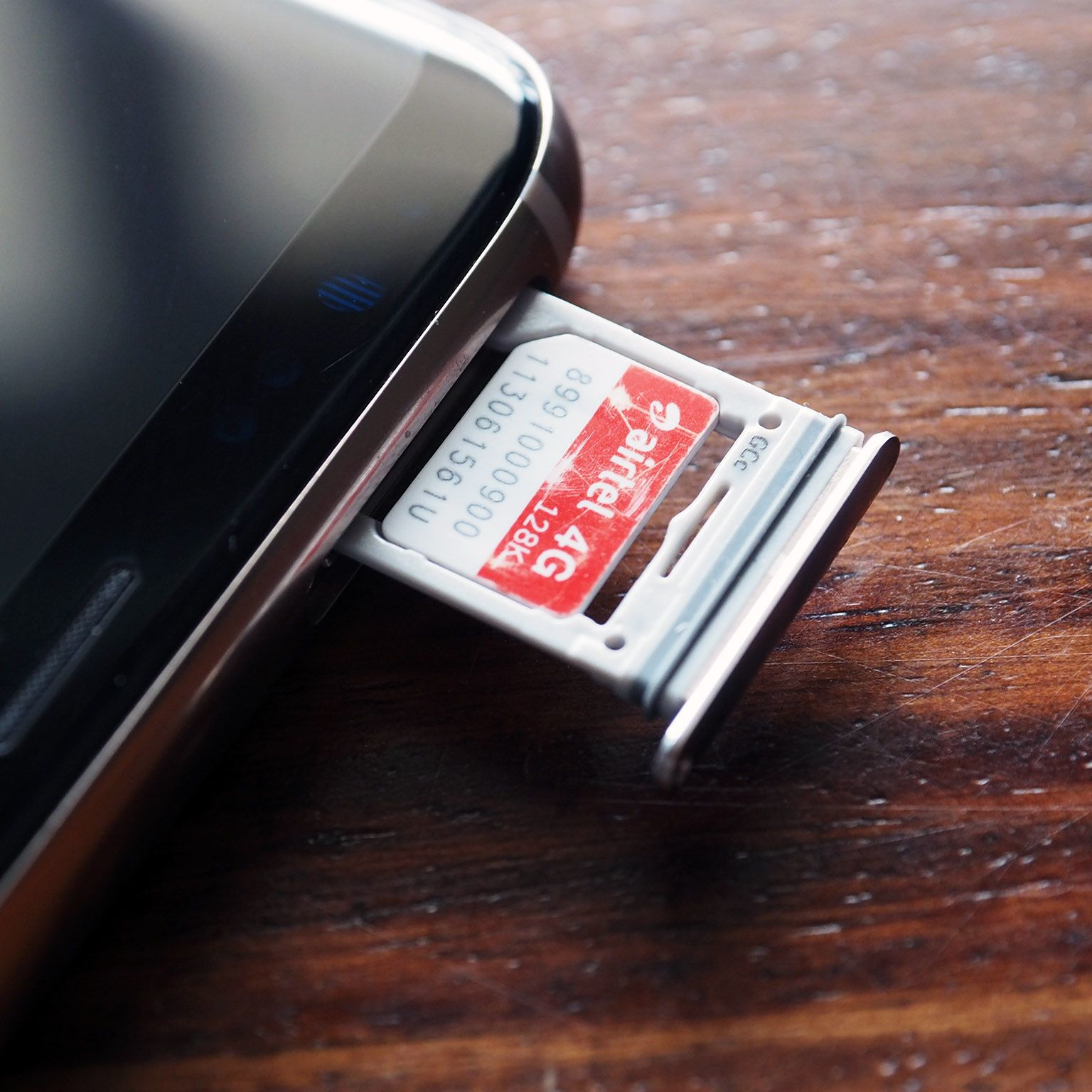 Airtel 4G SIM card being inserted into a smartphone for mobile connectivity in India