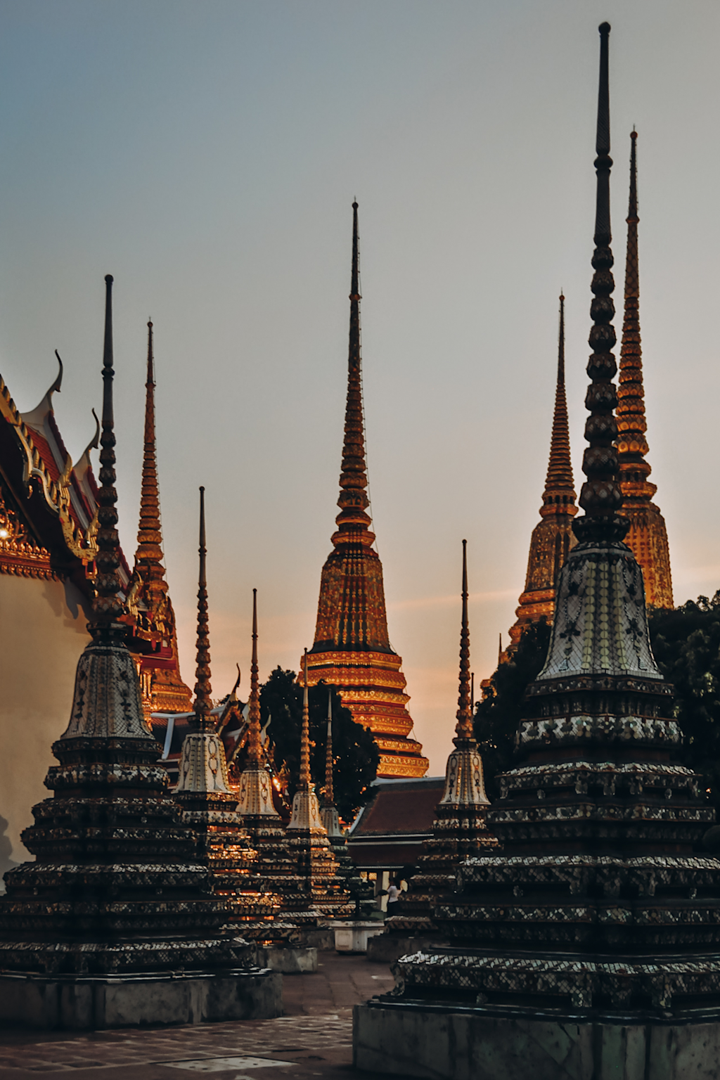Southeast Asian temple spires glowing at sunset, showcasing iconic cultural landmarks popular among travelers