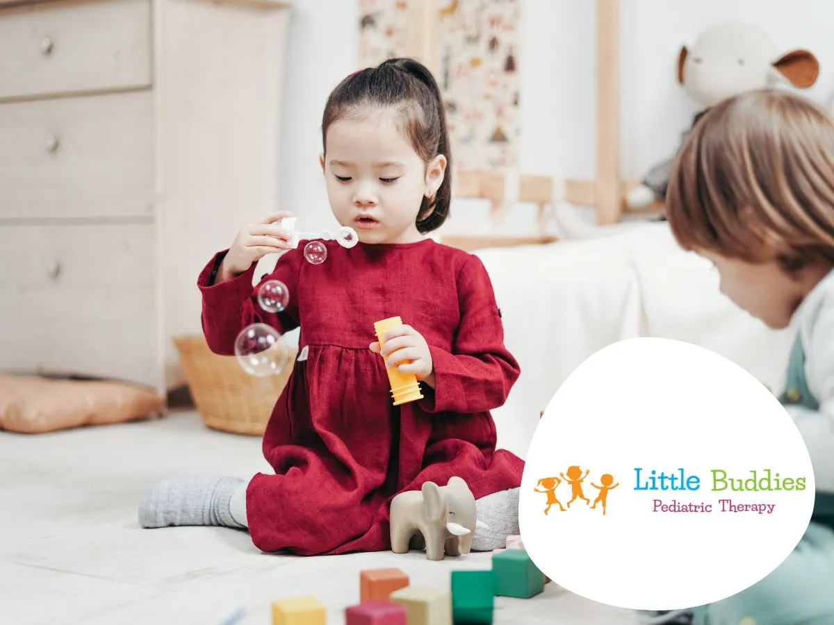 Children engaged in interactive play during a Floortime therapy session at a pediatric therapy center.
