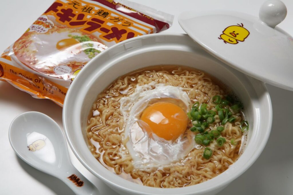 Chicken Ramen instant noodles with egg and green onions in a themed bowl featuring the Chicken Ramen chick mascot, related to the Fujiwa Minato Nijisanji collaboration