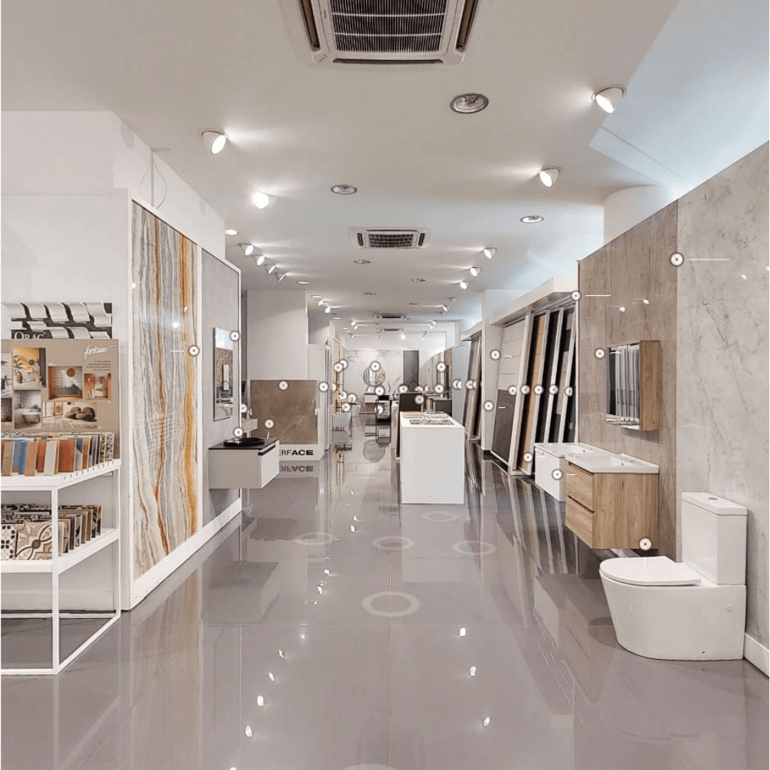A modern ceramics showroom displaying various tile patterns and bathroom fixtures relevant to Lebanon and Italy's ceramic trade