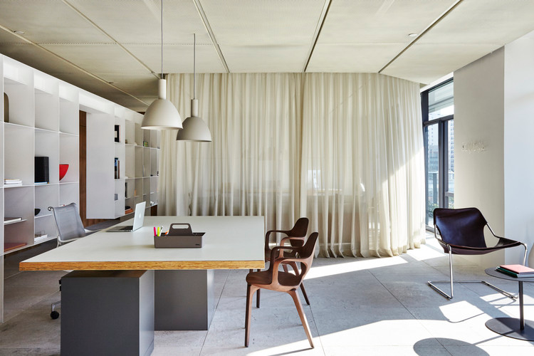 Sheer curtains used as non-permanent dividers to separate apartment spaces without construction