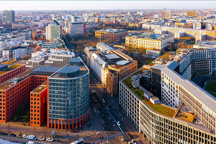 Aerial view of a modern European cityscape with commercial and residential buildings illustrating real estate development