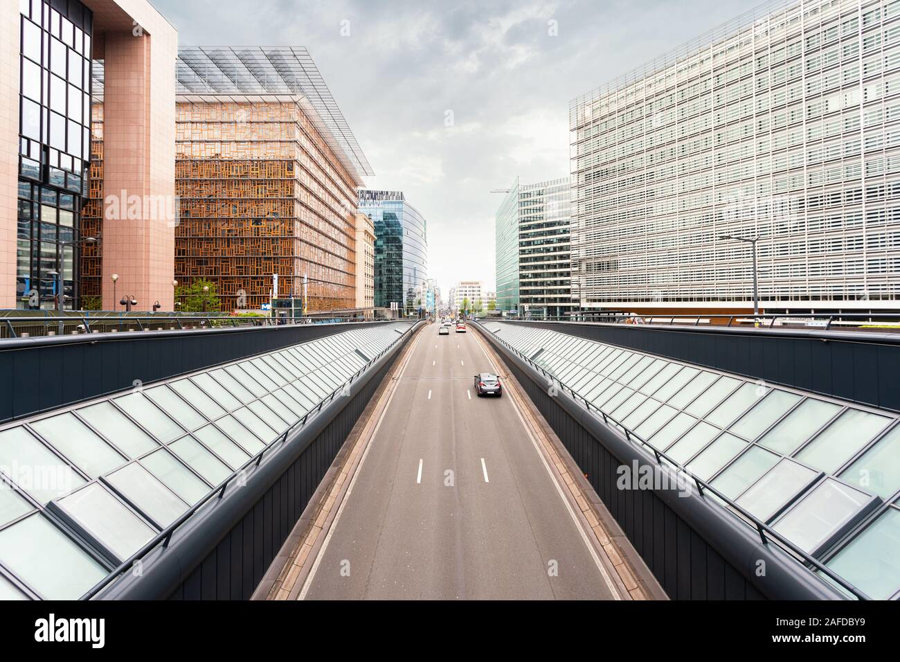 Modern office buildings and a broad boulevard in Brussels' European Quarter, showcasing contemporary architecture and urban design
