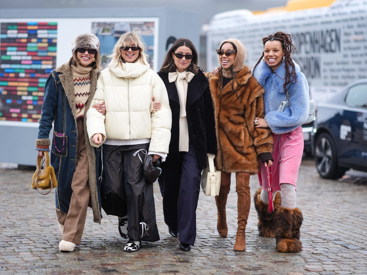 Women showcasing trendy winter layering outfits with wool blazers, sweaters, and faux fur accents