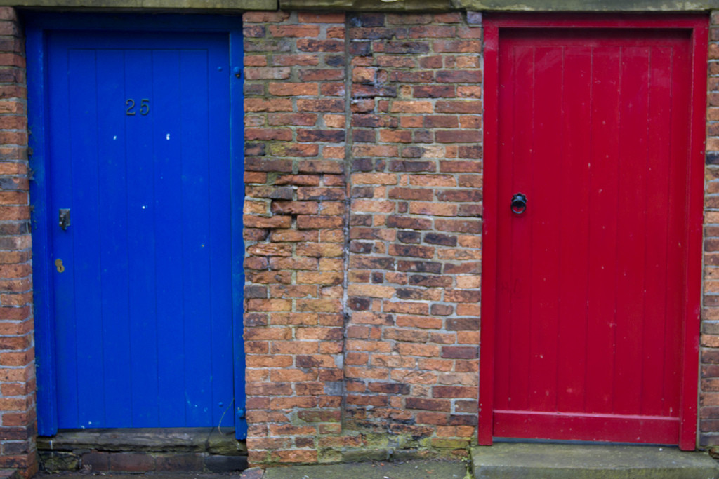 Two contrasting doors symbolize the concept of choosing between different options and the trade-offs involved in making decisions.