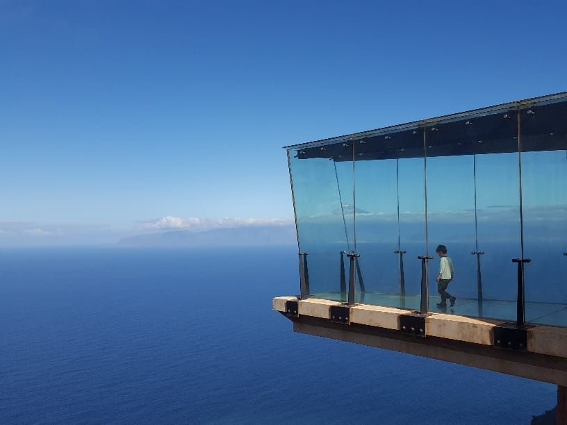 Glass observation deck at La Gomera’s Mirador de Abrante offers breathtaking ocean views and a thrilling experience for families