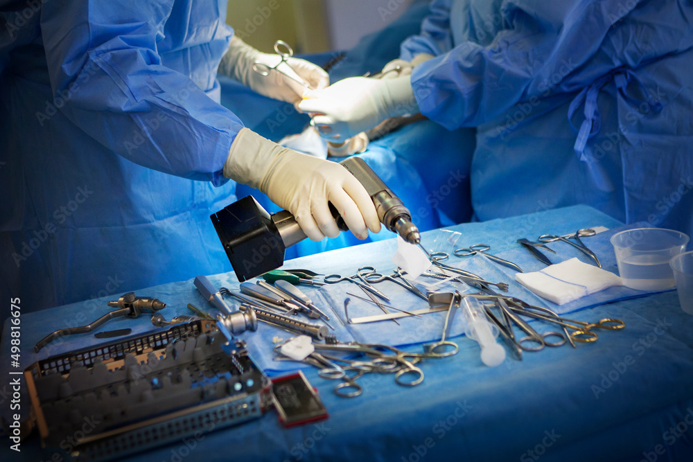 Orthopaedic surgeons performing surgery in operating room