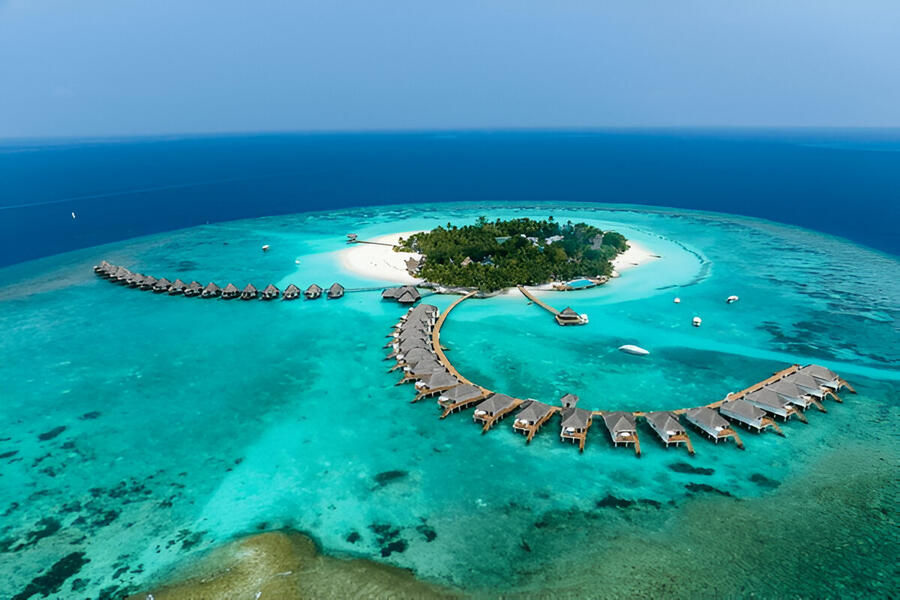 Aerial view of the Lakshadweep Islands showcasing turquoise lagoons, coral reefs, and overwater bungalows perfect for a serene and adventurous tropical getaway