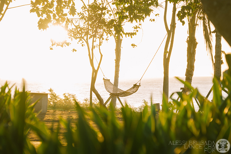 Sunset view with a hammock between palm trees at Alona Beach, Panglao, Bohol, Philippines, capturing an intimate tropical getaway setting