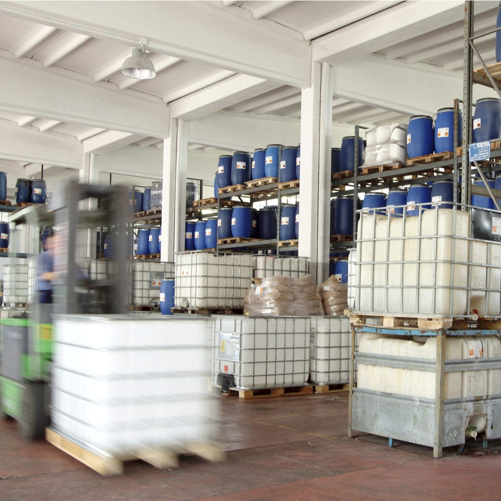 Bulk industrial cleaning products stored in a warehouse, illustrating large-scale cleaning product distribution