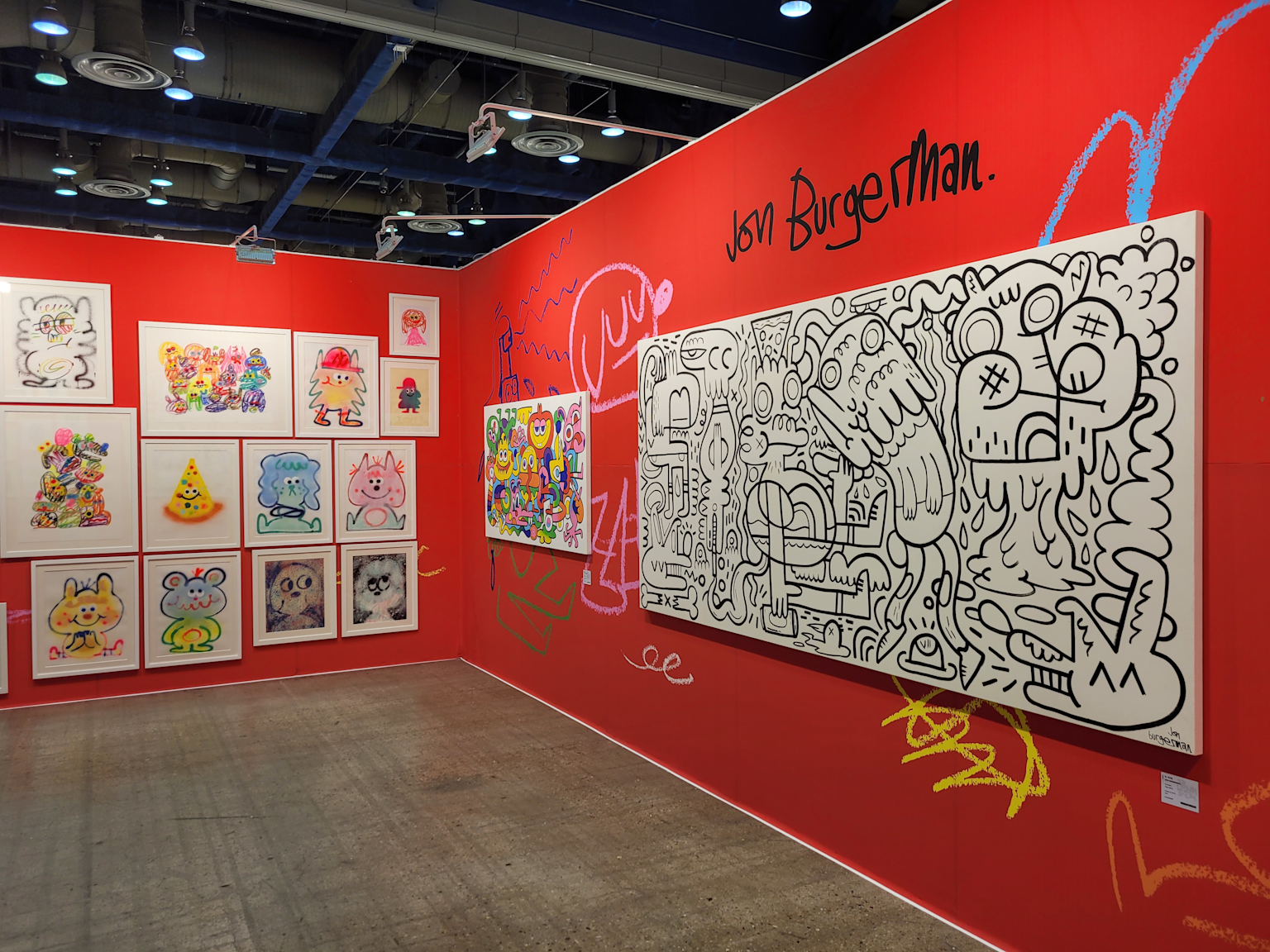 Art fair exhibit featuring contemporary colorful and black-and-white abstract artworks by Jon Burgerman.