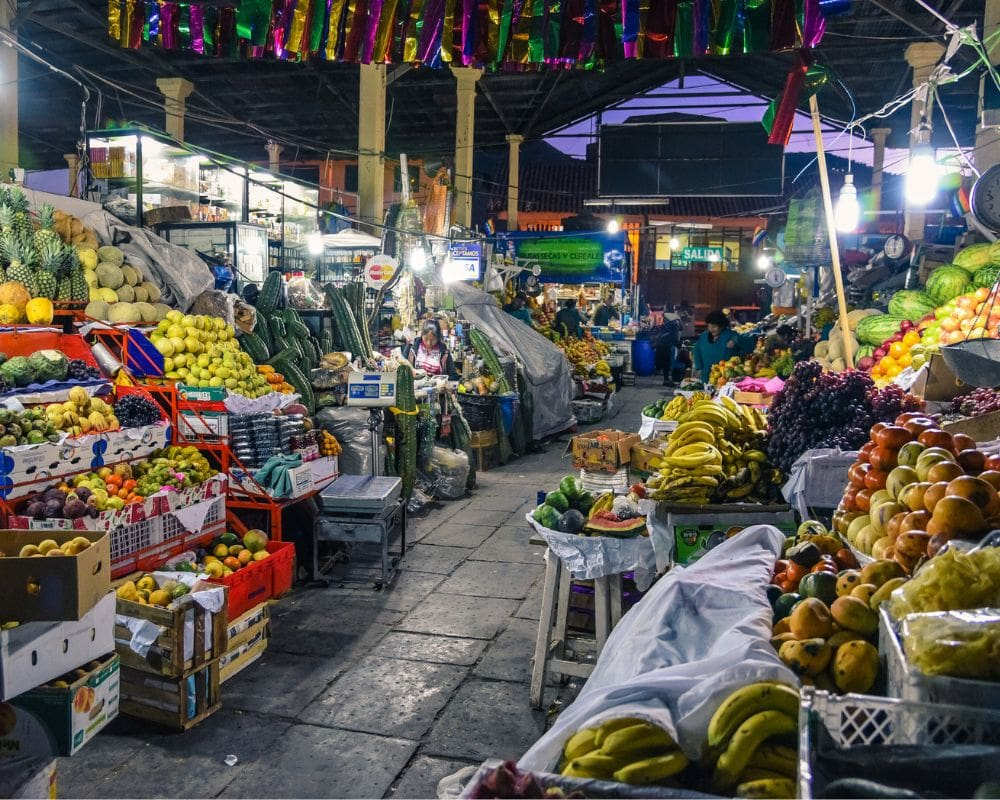 Traditional indoor market filled with colorful fresh fruits and vegetables, showcasing local culture and produce