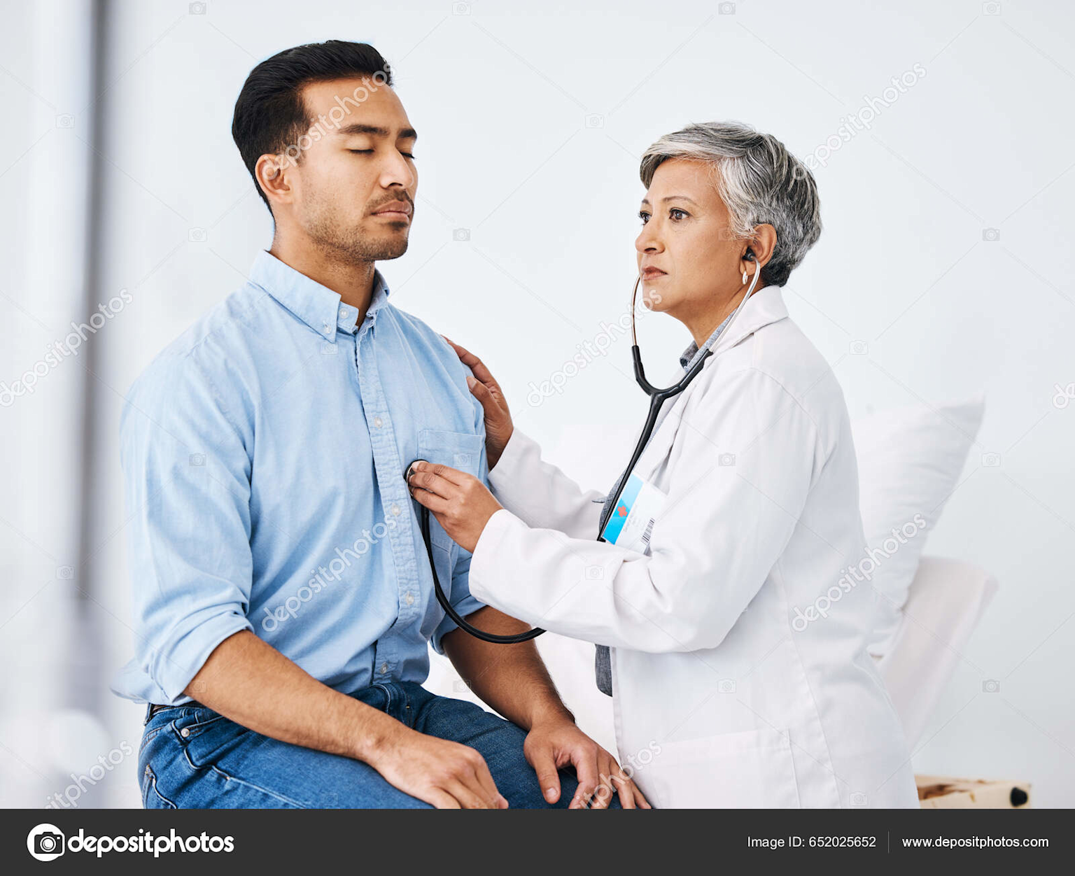 Heart specialist doctor using a stethoscope to examine a patient's heart during a medical consultation