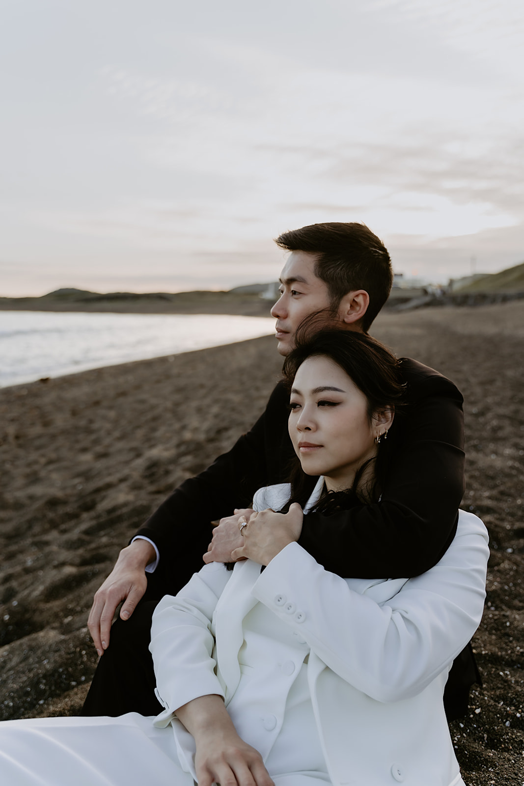 Couple enjoying a romantic sunset on a beach in Jeju Island, South Korea, capturing the essence of intimate travel experiences