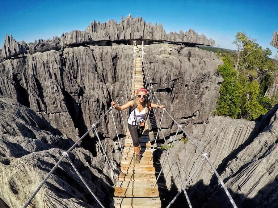 Hiking the narrow suspension bridge among Madagascar’s Tsingy de Bemaraha limestone pinnacles