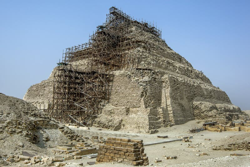 Ancient Egyptian pyramid under restoration with wooden scaffolding demonstrating historical scaffolding methods