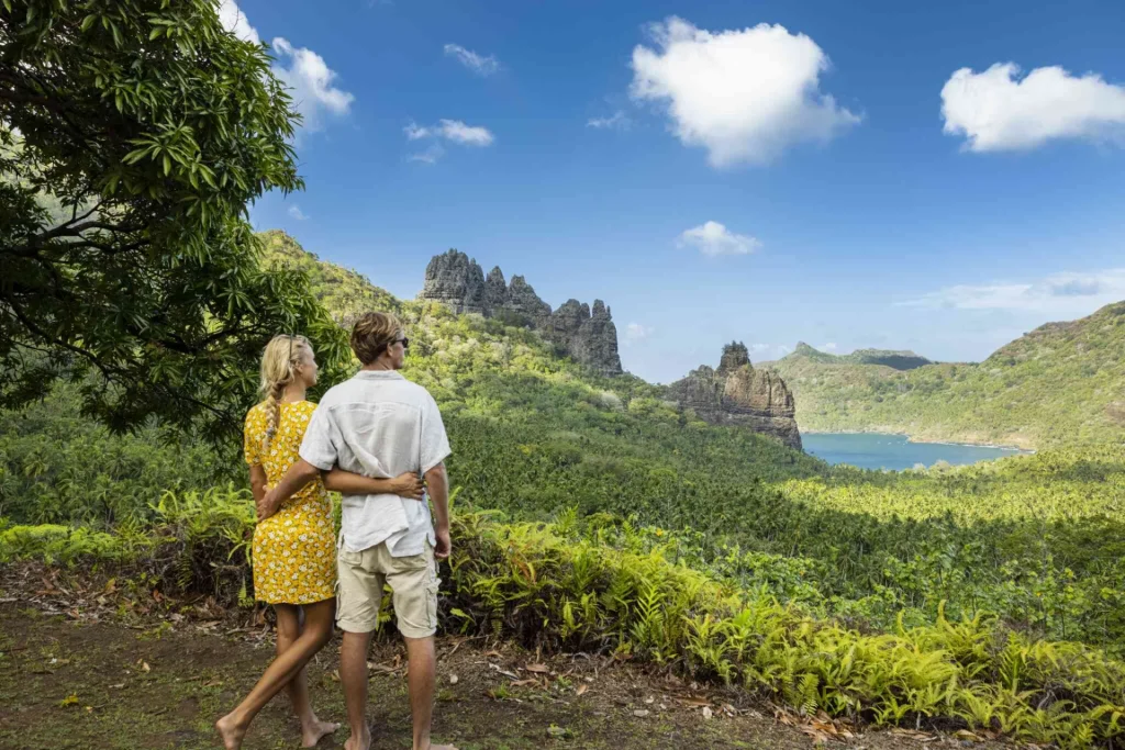 Couple enjoying the dramatic volcanic landscape and lush greenery of a secluded exotic travel destination