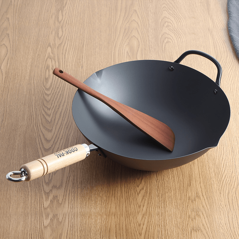 Yoshikawa Cook-Pal Ren carbon steel wok featuring wooden handle and dual handles for easy use.