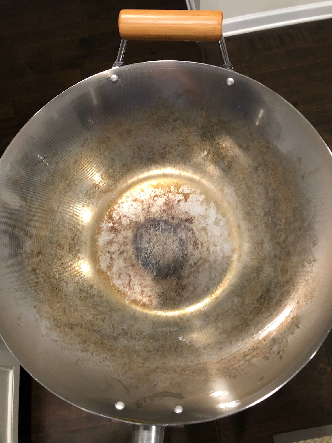 A wok with a seasoned patina from extensive use.