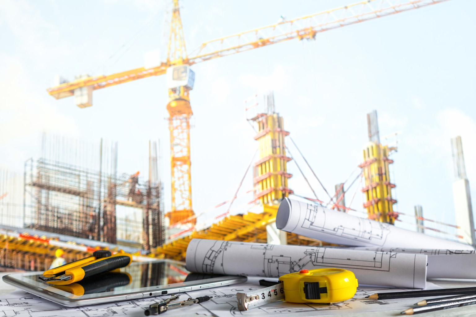 Professional construction site with blueprints, building materials, and construction equipment showcasing Excite Construction's expertise