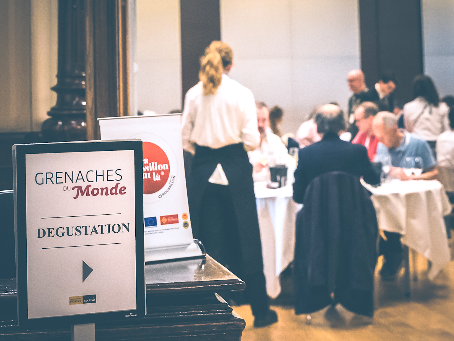 Wine tasting event at 'Grenaches du Monde' competition with judges evaluating wines