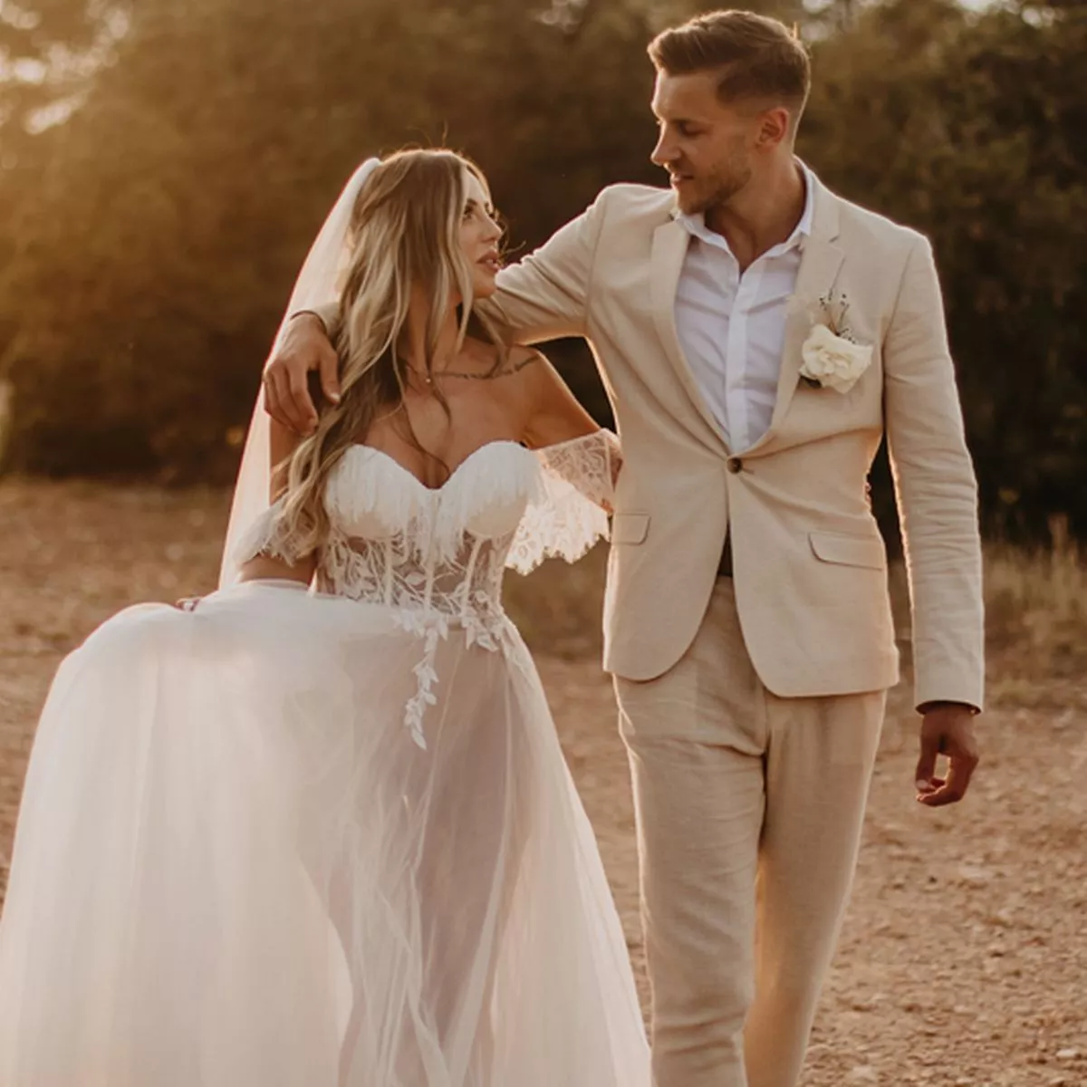 Holly Hagan and Jacob Blyth walking at their wedding in Ibiza, capturing a warm and romantic moment