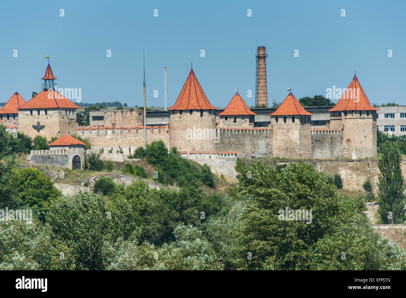Bender Fortress in Transnistria with its distinctive red-tiled towers and stone walls under a clear blue sky
