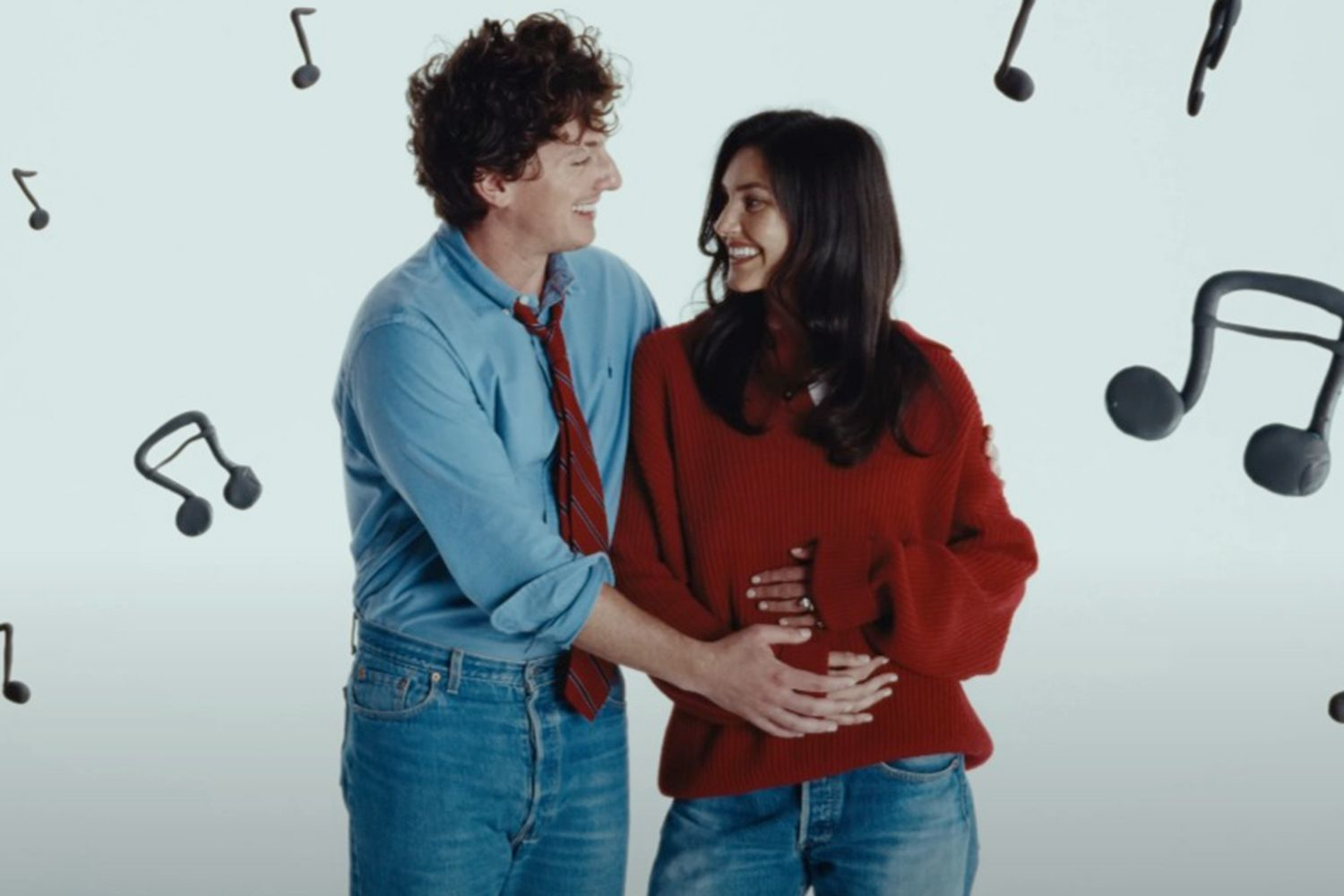 Charlie Puth and wife in a music video scene suggesting pregnancy announcement