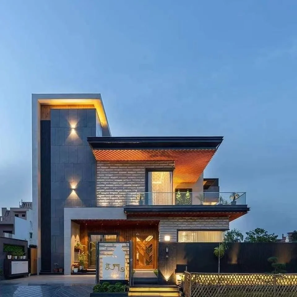 Modern two-story prefabricated house with light steel frame and warm exterior lighting