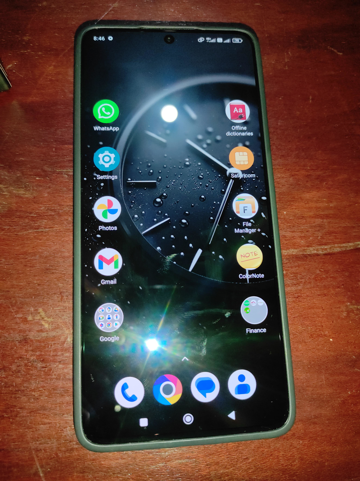 Poco X6 Pro home screen showing app icons and a watch-themed wallpaper on a wooden background