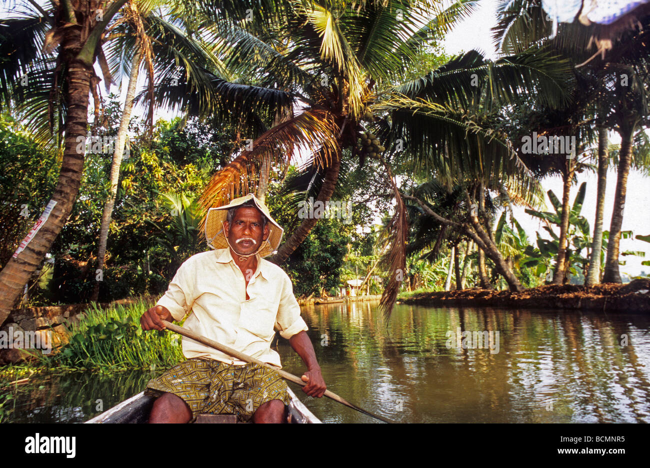 Man rowing small fiber boat