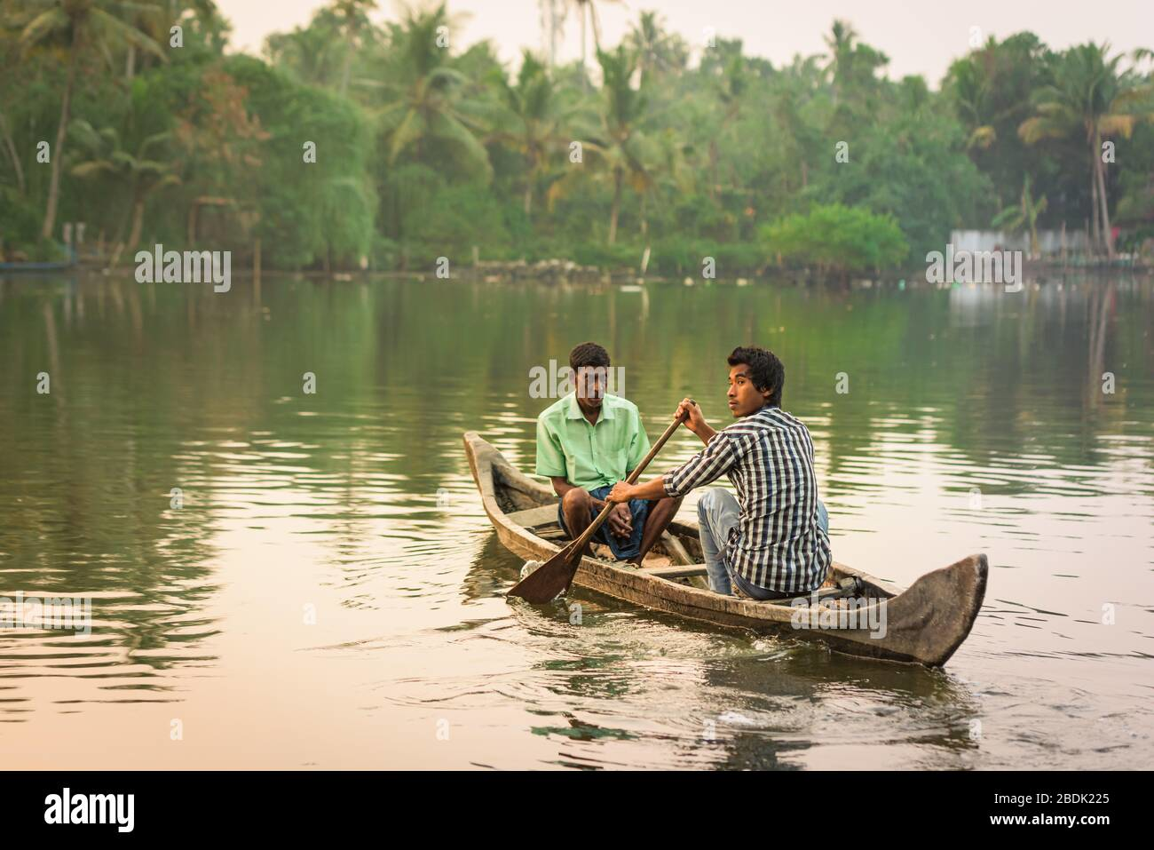 Two persons rowing boat in Kerala backwaters