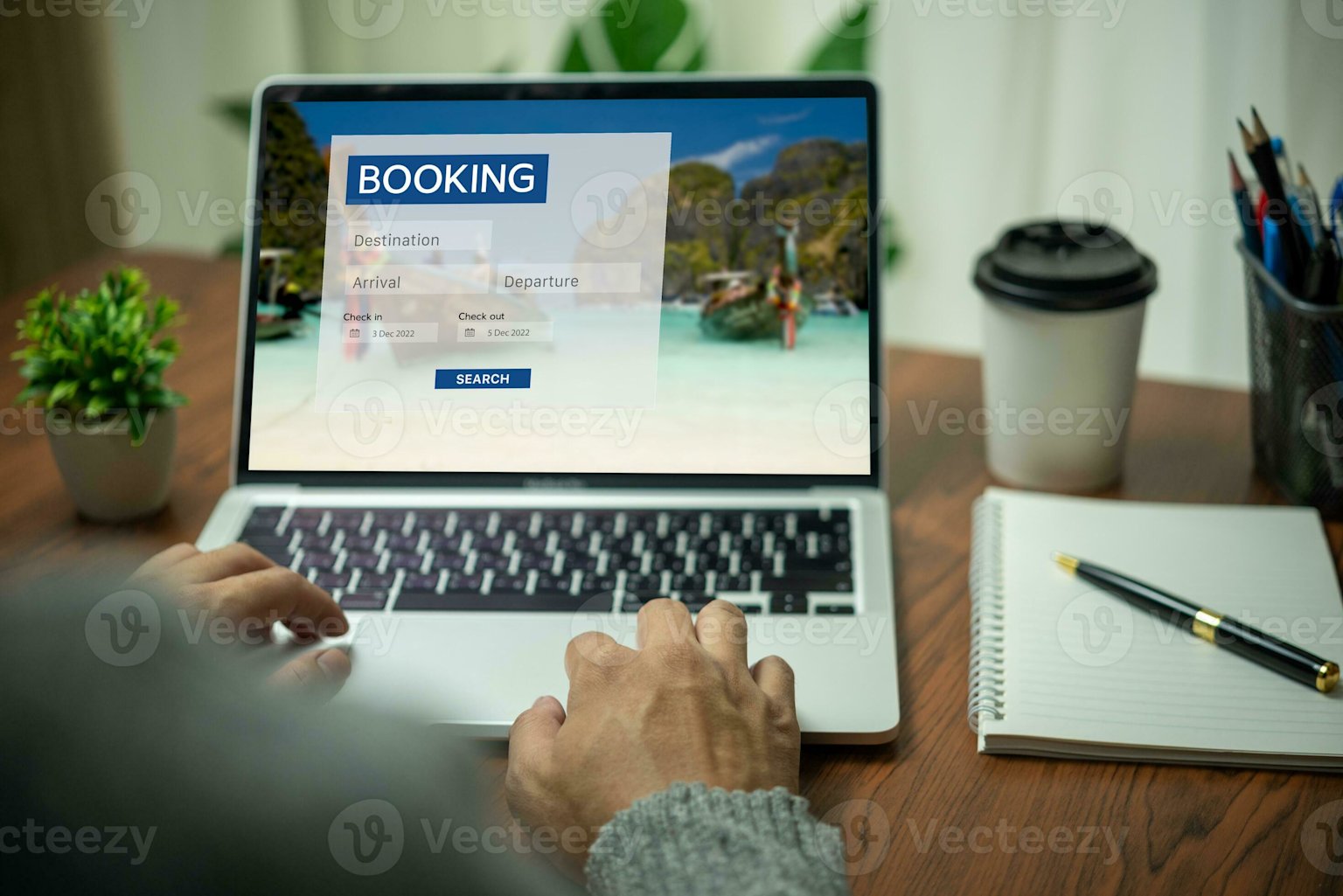 Person using an online travel booking platform on a laptop to search for travel options