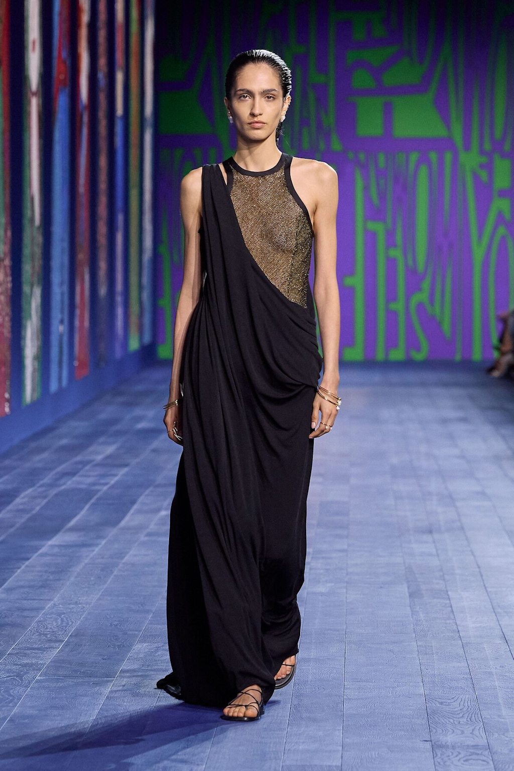 Model showcasing a black and gold gown at the Dior Autumn Winter 2024-2025 Couture fashion show