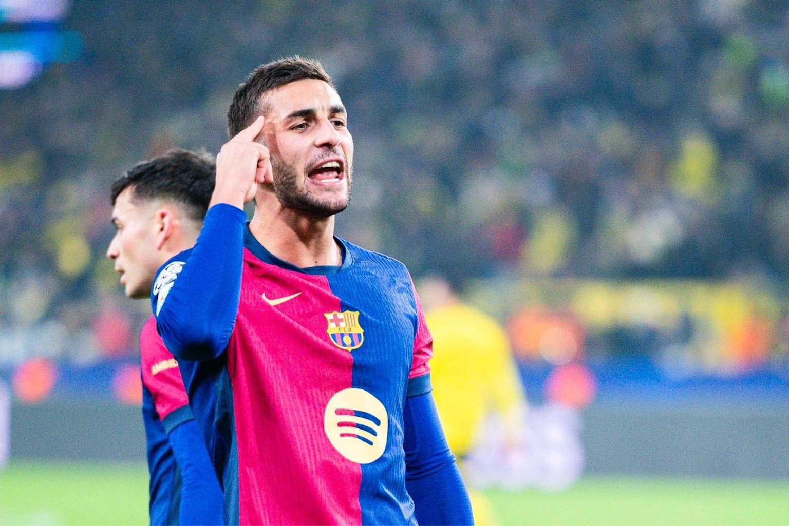 Ferran Torres celebrating a goal during a Barcelona match, highlighting his spirited expression and iconic club jersey.